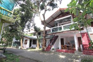 a house with a staircase leading up to it at Arjuna 31 in Yogyakarta