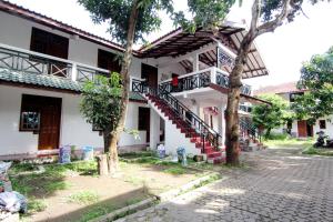 a white building with a staircase in front of it at Arjuna 31 in Yogyakarta