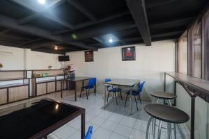 a restaurant with tables and chairs in a room at RedDoorz near Cikampek Mall Karawang in Karawang +7 photos