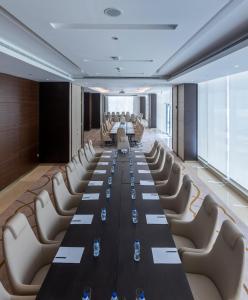 a conference room with a long table and chairs at Ascott Rafal Olaya Riyadh in Riyadh +66 photos