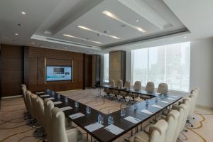 a large conference room with a long table and chairs at Ascott Rafal Olaya Riyadh in Riyadh +38 photos
