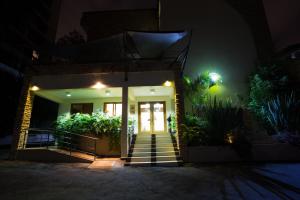 a house with stairs leading to the front door at night at Reata Apartment Hotel in Nairobi