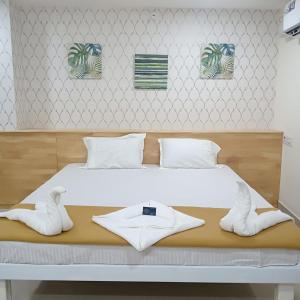 a bedroom with a bed with white shoes on it at ADITI ROOMS in Tiruchchirāppalli