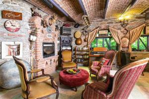 a living room with chairs and a stone wall at Stonehouse in Selçuk