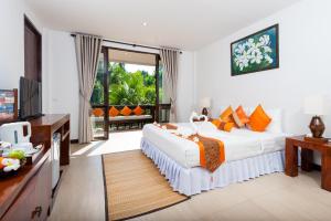 
a hotel room with a bed and a table at Ban's Diving Resort SHA Extra Plus in Ko Tao
