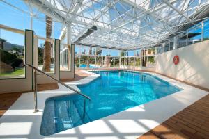 a large swimming pool with a glass ceiling at Camping Villasol in Benidorm