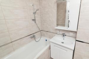 a bathroom with a shower and a white sink at проспект Михайла Лушпи in Sumy