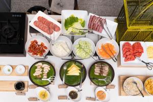 a table with plates of food on it at The Aviary Hotel in Siem Reap