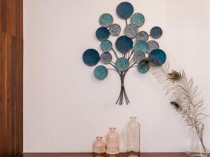 a wall with a decoration of a tree on it at The Aviary Hotel in Siem Reap