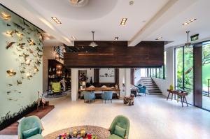 a living room with a table and chairs at The Aviary Hotel in Siem Reap