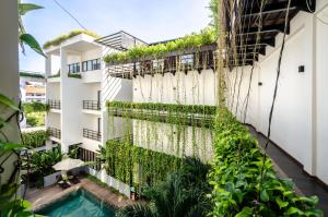an external view of a building with plants at The Aviary Hotel in Siem Reap