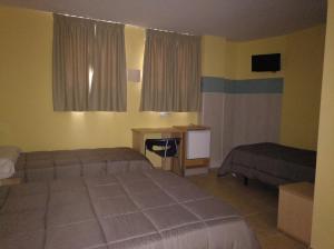 Postel nebo postele na pokoji v ubytování Hostal Ducal