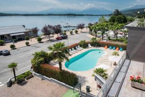 an apartment with a swimming pool and a view of the water at Hotel Royal in Viverone