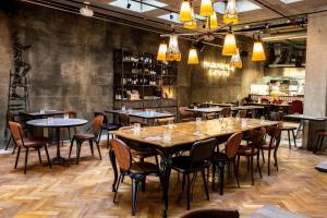 a row of tables and chairs in a restaurant at Urban Creme in Prague