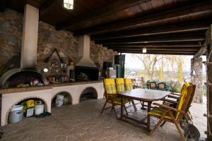 a table and chairs in a kitchen with a fireplace at Nature Villa in Panayía