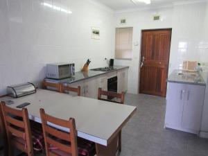 a kitchen with a table and chairs and a counter top at Dolphin view in Margate
