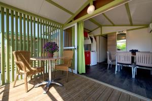a screened in porch with a table and chairs at Camping Villasol in Benidorm