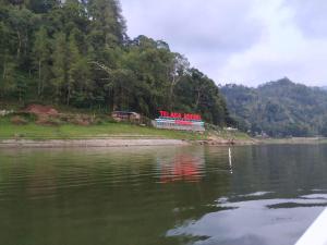 a sign on the shore of a body of water at Hotel "NGEBEL INDAH" in Ngebel