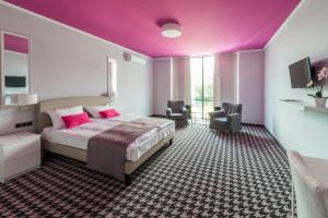 a bedroom with a large bed and a purple ceiling at Hotel Sękowski in Legnica +45 photos