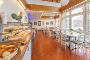 a restaurant with tables and chairs and a bakery at Hotel Gasthof Zum Rössle in Heilbronn