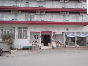 a building with dogs sitting in the windows at Ermionida in Kranidi