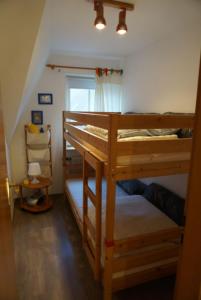 a bedroom with two bunk beds and a window at Tolle Ferienwohnung in schönem Bauernhaus in Fehmarn