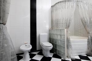 a bathroom with a toilet and a sink and a tub at Апартаменты возле Вокзала, Центр in Dnipro
