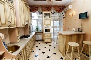a kitchen with a sink and a stove top oven at Апартаменты возле Вокзала, Центр in Dnipro