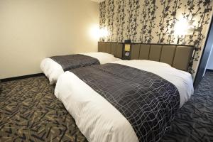 Postel nebo postele na pokoji v ubytování APA Hotel Mie Kameyama