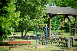 a park with a swing set and a pavilion at Oliver Inn Camping in Balatonlelle
