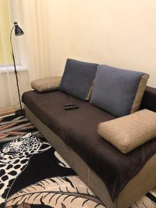a brown couch sitting in a living room at Apartament at Park in Lviv