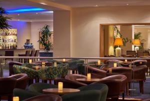 a restaurant with tables and chairs and a bar at PortoBay Falesia in Albufeira