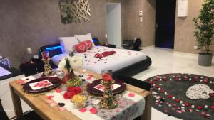 a room with a bed and a table with food on it at Dreamspa in Audincourt