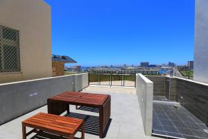 a balcony with two benches and a view of the city at Sharp B&B in Magong