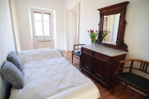 um quarto com uma cama, uma cómoda e um espelho em Panorama em Aurisina
