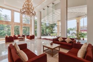 a living room filled with furniture and a large window at Seashell Suites and Villas in Candolim