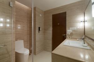 a bathroom with a sink, toilet and bathtub at Seashell Suites and Villas in Candolim
