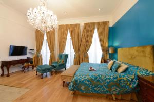 a blue bedroom with a bed and a desk at Twenty Nevern Square Hotel in London