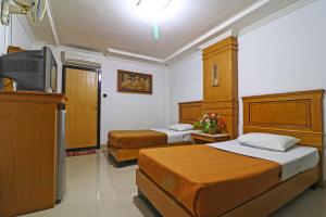 Hotel SAS Syariah客房内的一张或多张床位