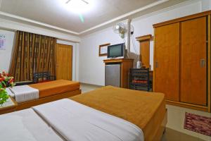 Hotel SAS Syariah客房内的一张或多张床位