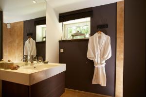 a bathroom with a sink and a mirror at Les Chambres de l'Oustalet, Chambres d'hôtes et Restaurant étoilé in Gigondas +35 photos