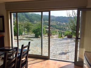 a dining room with a large sliding glass door at Quinta do Pêso in Amarante