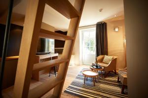 a living room with a staircase leading to a living room at Les Chambres de l'Oustalet in Gigondas