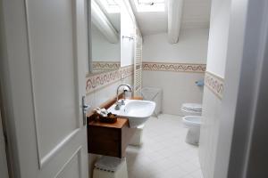 a bathroom with a sink and a toilet at Locanda Orologio in Cormòns +67 photos