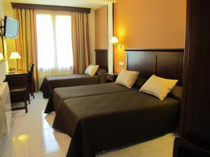 Cama o camas de una habitación en Hotel Turmo