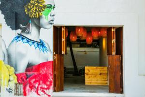 a painting of a woman on the side of a wall at Santuario Getsemani Hostel in Cartagena de Indias