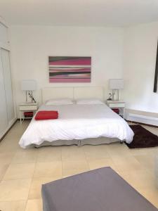 a bedroom with a white bed and two night stands at CALA BLANCA-TORRE BELLVER in Cala Blanca +31 photos