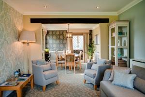a living room with a couch and chairs and a table at Oakley Hall Hotel in Basingstoke