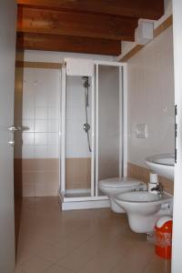 a bathroom with a shower and a toilet and a sink at Trentino in malga: Malga Zanga in Arco