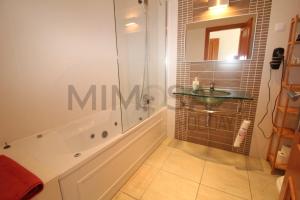 a bathroom with a tub and a sink and a shower at Alba Mar in Lagos